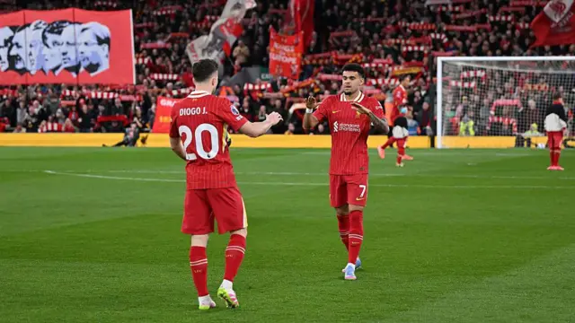 Luis Diaz of Liverpool high fives teammate Diogo Jota