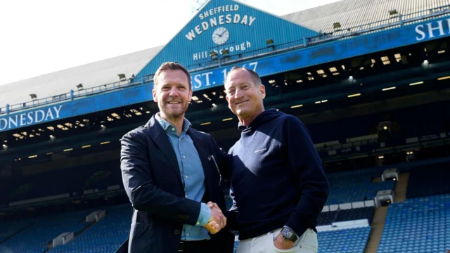 David Bruce is shaking hands with David Storch, in the Sheffield Wednesday stadium.