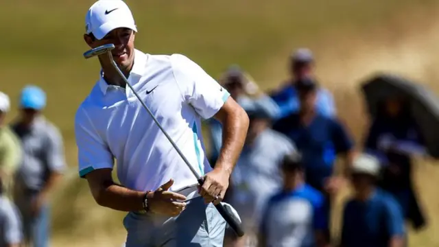 Rory McIlroy watches his putt