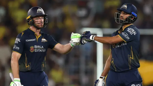 Jos Buttler punches gloves with Washington Sundar