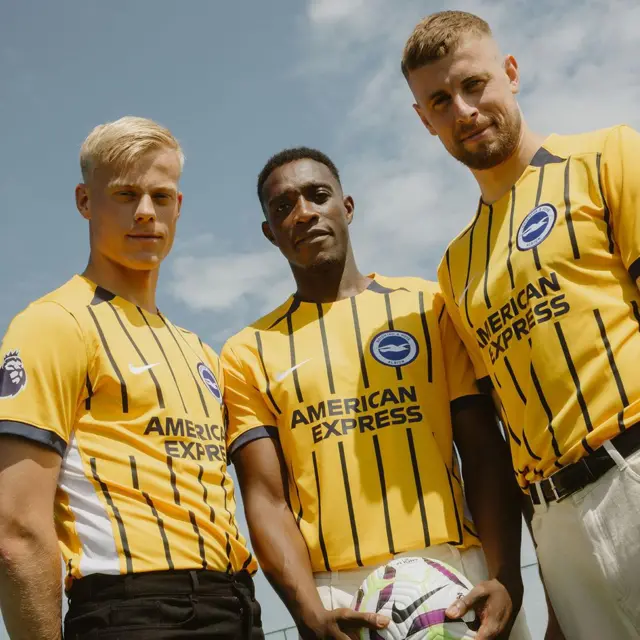 Brighton players wearing new gold and navy striped away kit