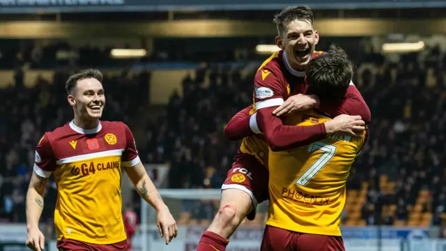 Motherwell's Tom Sparrow celebrates with Steve Seddon and Kofi Balmer (L) as he scores to make it 2-0 during a William Hill Premiership match between Motherwell and St Johnstone at Fir Park