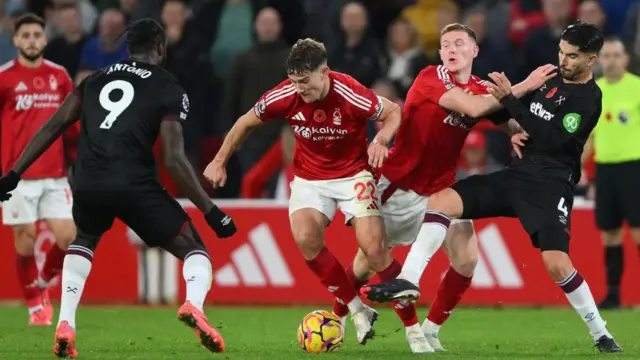 Ryan Yates of Nottingham Forest is under pressure from Michail Antonio of West Ham United during the Premier League match between Nottingham Forest and West Ham United at the City Ground