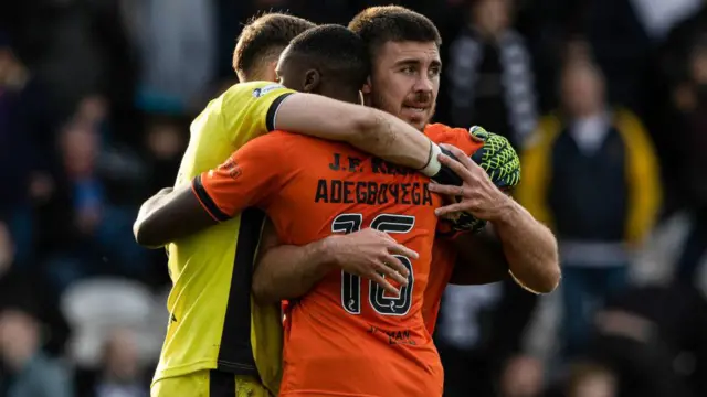 Dundee United's Jack Walton, Emmanuel Adegboyega and Declan Gallagher celebrate at full time during a William Hill Championship match between St Mirren and Dundee United at the SMiSA Stadium,