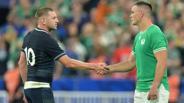 Finn Russell of Scotland congratulates Jonathan Sexton of Ireland for his win after the Rugby World Cup France 2023 match between Ireland and Scotland at Stade de France on October 7, 2023 in Paris, France