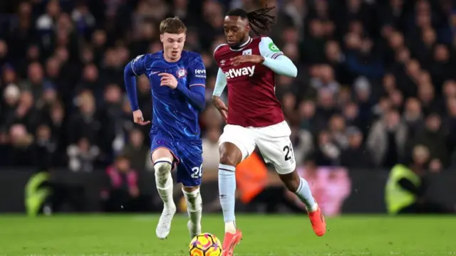 Aaron Wan-Bissaka of West Ham United takes on Chelsea's Cole Palmer