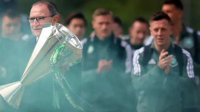 : Former Celtic manager Martin O'Neill walks up towards the stadium with the SPL trophy during the Cinch Scottish Premiership match between Celtic and Aberdeen at Celtic Park Stadium