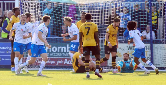 Theo Vassell of Barrow celebrates after heading in the second goal against Newport County