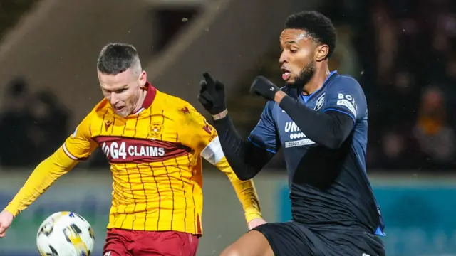 Motherwell's Paul McGinn and Rangers' Youssef Chermiti