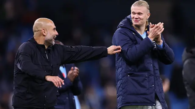 Pep Guardiola and Erling Haaland share a positive interaction, with Guardiola laughing