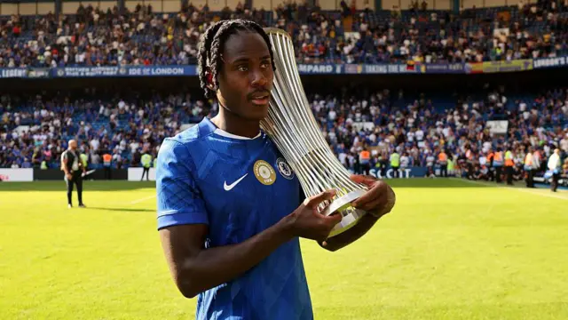 Trevoh Chalobah of Chelsea walks around with the UEFA Conference League Trophy 