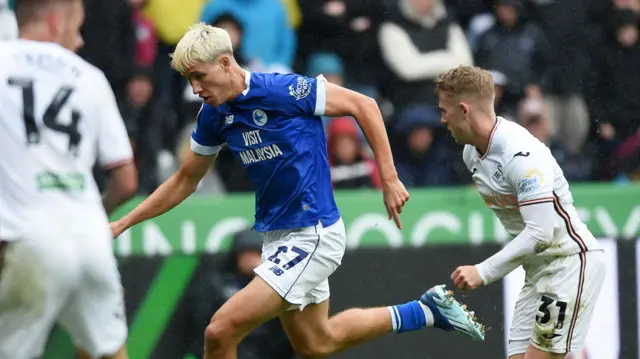 Cardiff City's attacking midfielder Rubin Colwill runs beyond Swansea City's attacking midfielder Ollie Cooper