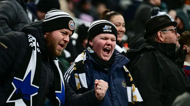 Two Newcastle United fans shout from stand