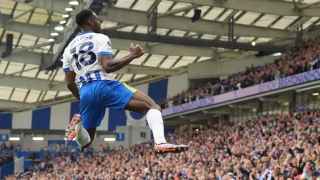 Danny Welbeck jumps to celebrate a goal for Brighton