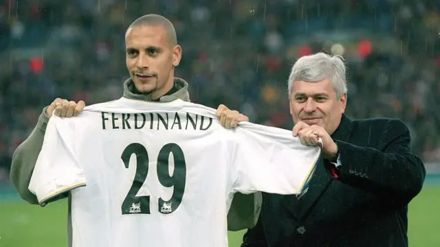 Leeds United record signing Rio Ferdinand receives his new shirt from Leeds United chairman Peter Risdale