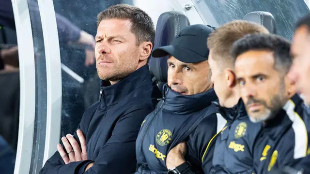Xabi Alonso sits in his coaching dugout
