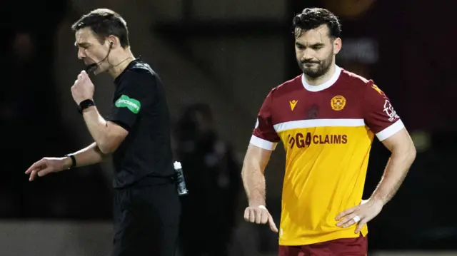 Referee Kevin Clancy and Motherwell striker Tony Watt