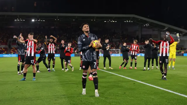 A general view as Kevin Schade of Brentford celebrates victory in front of fans of Brentford with his hat-trick match ball after the Premier League match between Brentford FC and Leicester City FC at Gtech Community Stadium