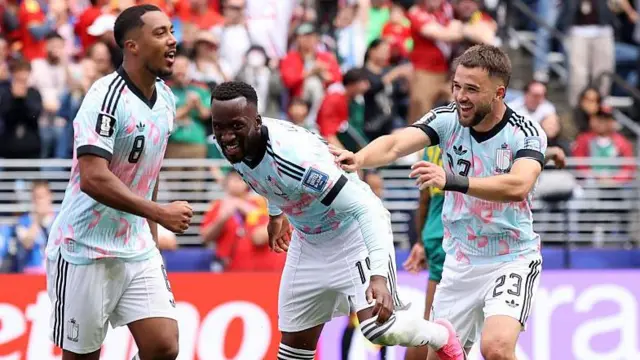 Belgium's Youri Tielemans, Dodi Lukebakio and Nicolas Raskin celebrate