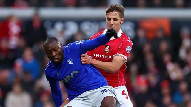 Edo Kayembe of Watford is challenged by Max Cleworth of Wrexham during the clubs' meeting earlier this season