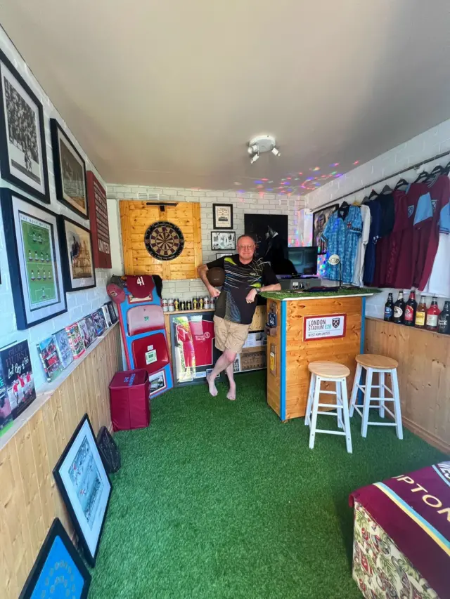 Supporter posing with his West Ham-themed home bar