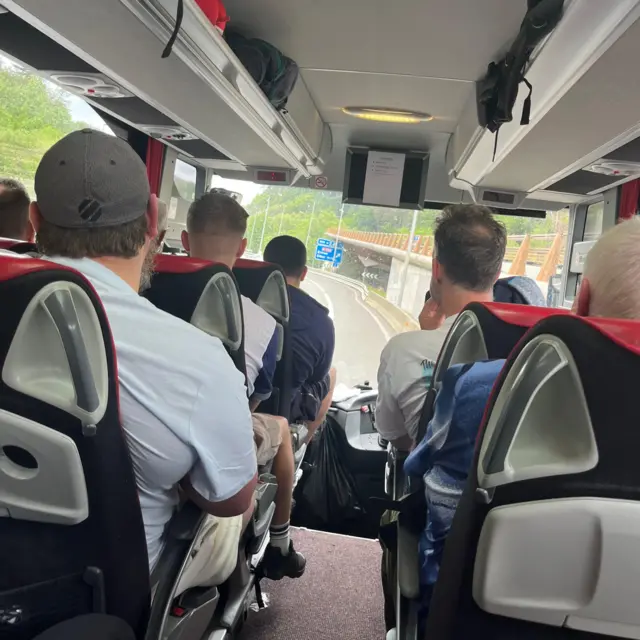 A group of people sat on a coach