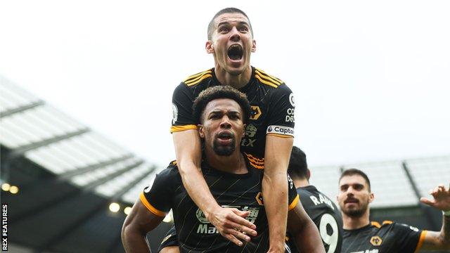 Adama Traore celebrates a Wolves goal with team-mate Conor Coady