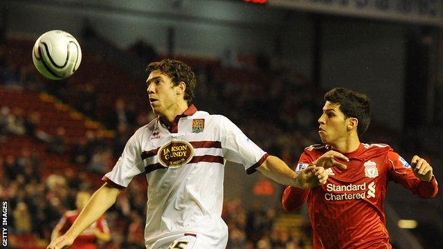 Northampton's Ben Tozer in action with Liverpool's Daniel Pacheco during a League Cup tie at Anfield in 2010