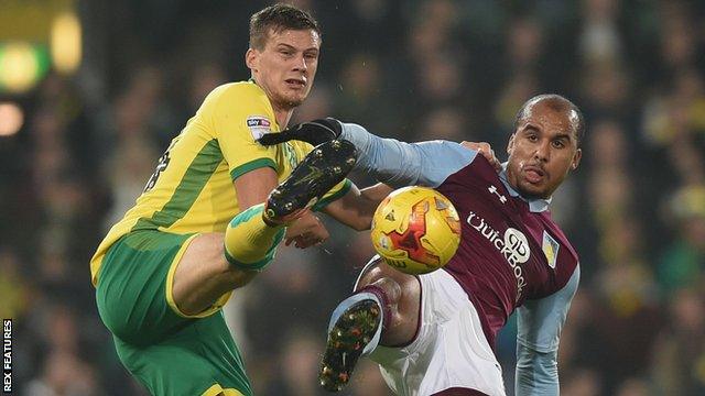 Ryan Bennett of Norwich City challenges Aston Villa's Gabriel Agbonlahor