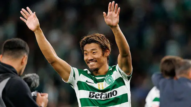 Hidemasa Morita of Sporting with his arms in the air saluting supporters