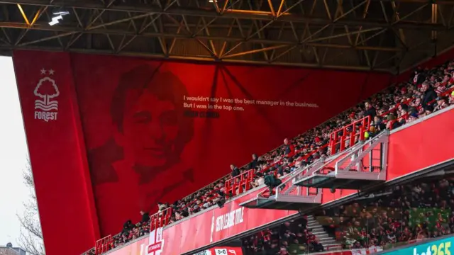 A quote and image of former manager Brian Clough seen next to fans in the Peter Taylor Stand