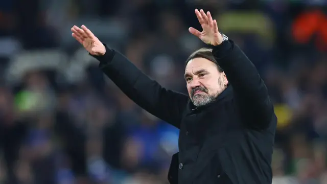 Leeds United boss Daniel Farke with his arms raised.