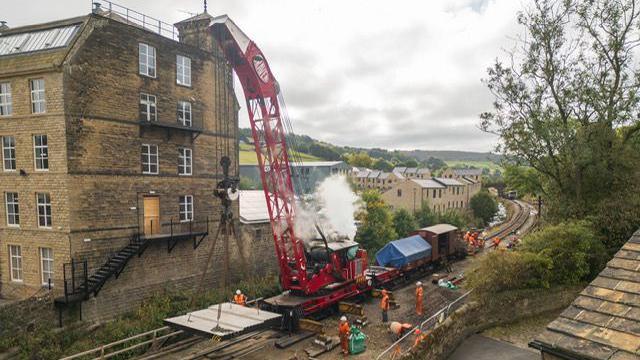 The Bahamas Locomotive Society 50-tonne steam crane lifting a concrete pad into position on the railway line