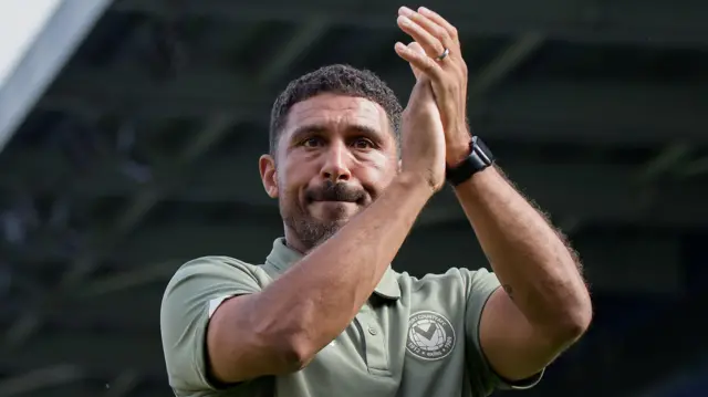 Hayden Mullins applauds the Newport County fans after defeat by AFC Wimbledon