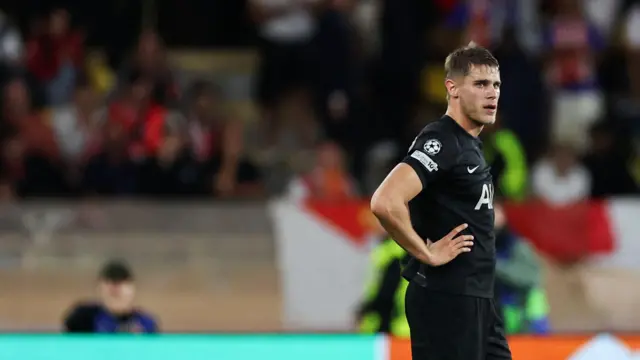 Micky van de Ven looks on with hands on hips