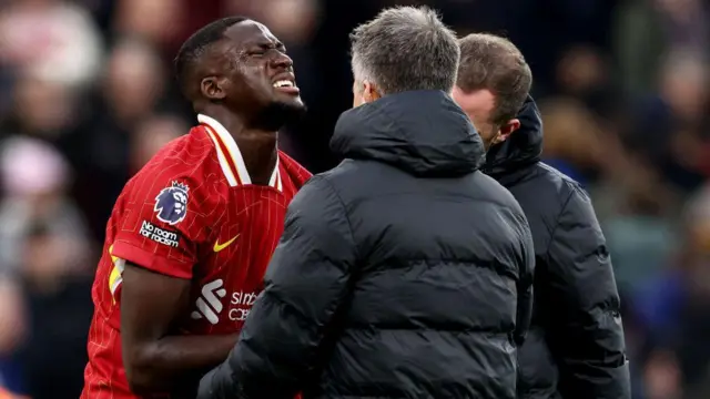 Liverpool's French defender #05 Ibrahima Konate reacts to an injury during the English Premier League football match between Liverpool and Brighton and Hove Albion at Anfield