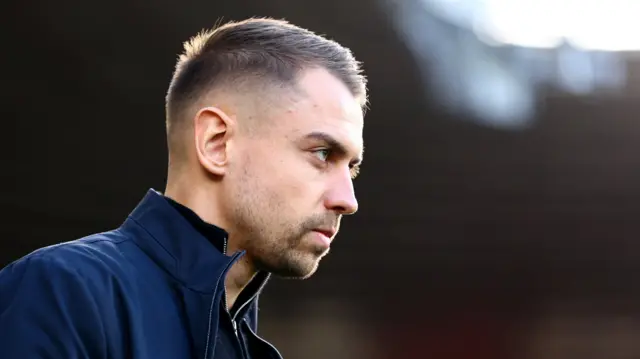 Tonda Eckert, with his head slightly stooped, staring ahead of him