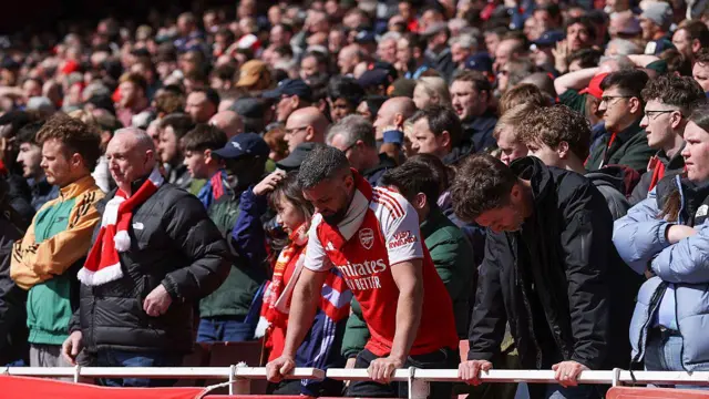 Arsenal supporters look dejected