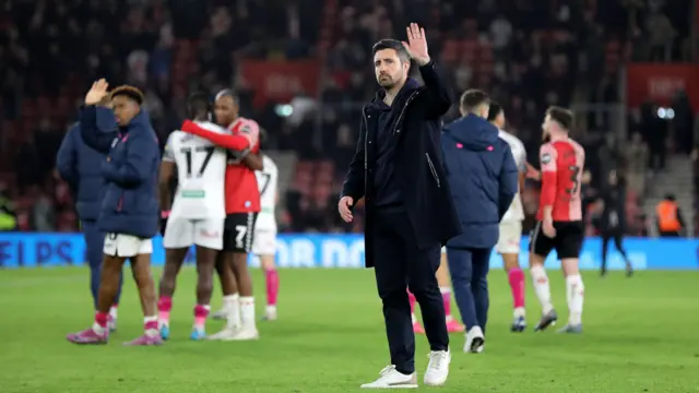 Alan Sheehan raises a hand in apology after Swansea's thrashing at Southampton in December 2023