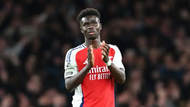 Bukayo Saka of Arsenal applauds the fans after he is substituted during the Premier League match between Arsenal FC and Liverpool FC at Emirates Stadium on October 27, 2024