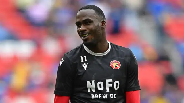 Levi Amantchi warming up ahead of the 2025 League Two play-off final for Walsall