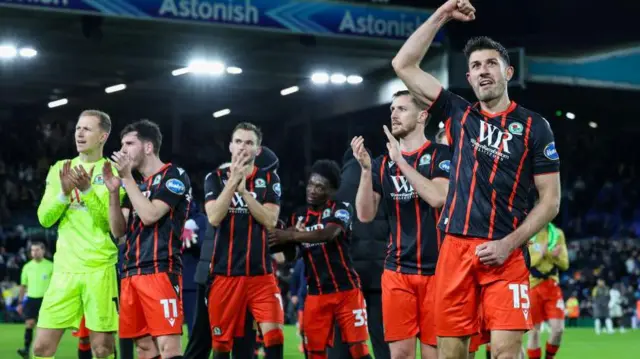 Blackburn Rovers players celebrate in front of the away fans after their draw at Leeds United