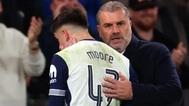 Ange Postecoglou embraces Mikey Moore after substituting him in a Tottenham match