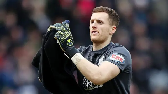 Preston goalkeeper Jack Walton dries his gloves on a towel