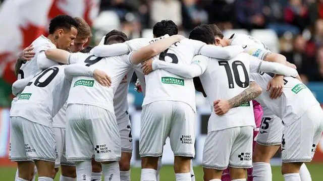 Swansea players in a huddle 