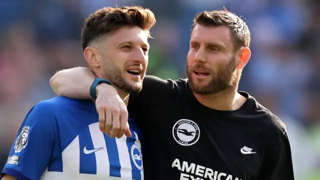 Adam Lallana and James Milner embrace