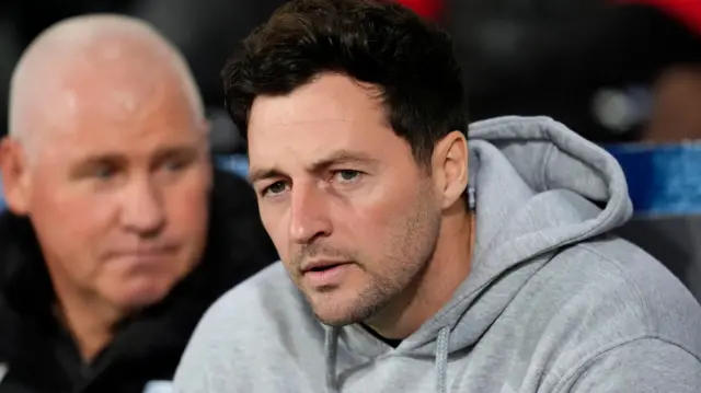 West Brom boss Ryan Mason sits in the dugout