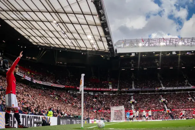 Bruno Fernandes with his arm in the air before taking a corner during Manchester United's game against Nottingham Forest at Old Trafford