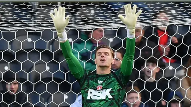 Thomas Kaminski holds his hands up in goal for Charlton