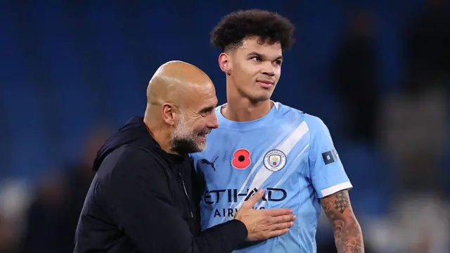 Pep Guardiola celebrates with Nico O'Reilly